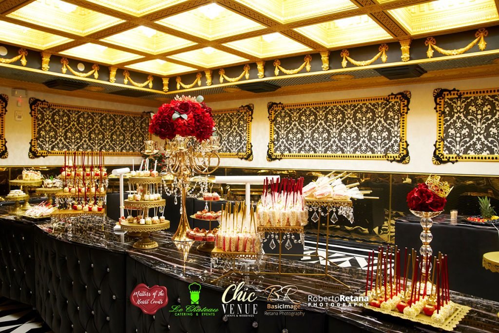 Dessert display with red roses and gold accents