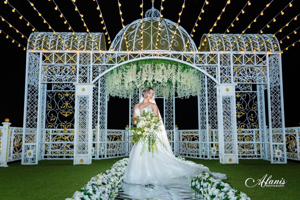Bride under a white lit gazebo outdoors