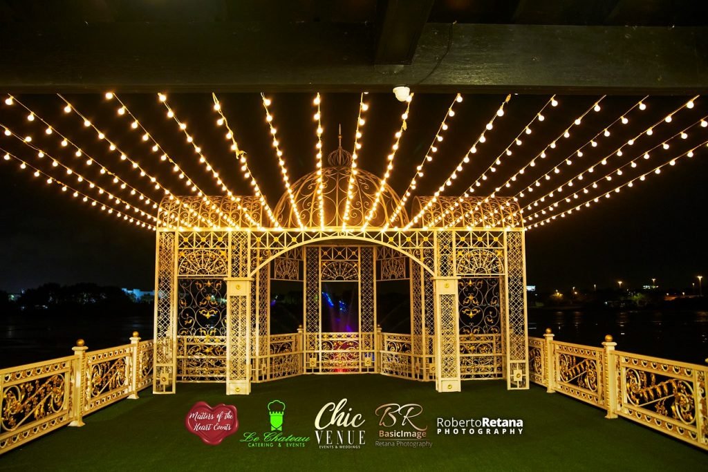 Outdoor pavilion glowing with string lights at night