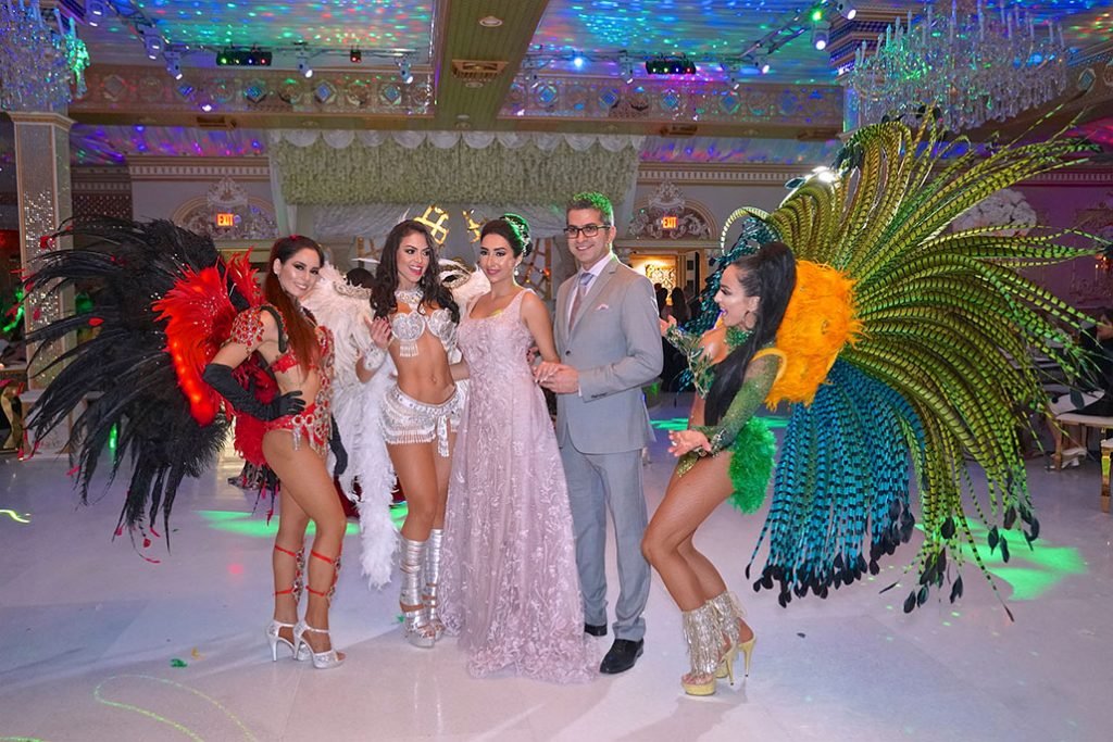 Costumed performers with guests at a party