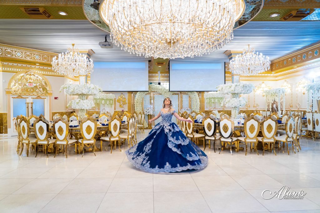 Quinceañera in a navy gown in the ballroom