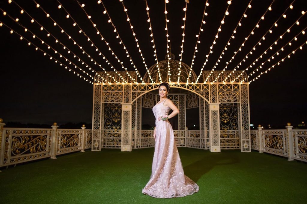 Birthday girl under string lights in the outdoor area at night